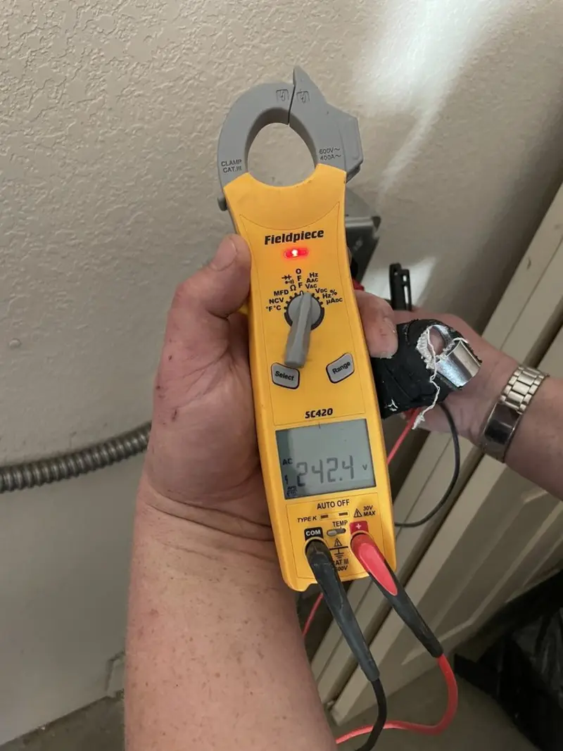 Voltage testing with clamp meter during Electrical Installation Services in Luling